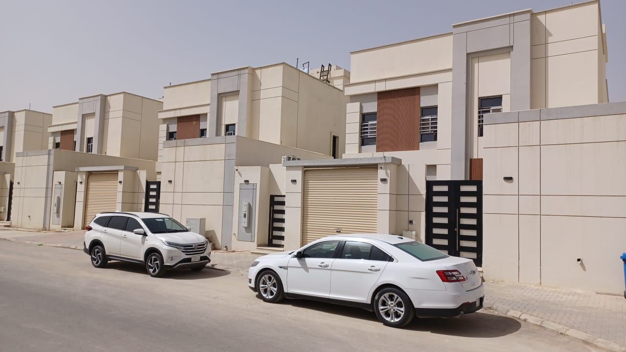 Completed villa street with boundary walls and gated entrances